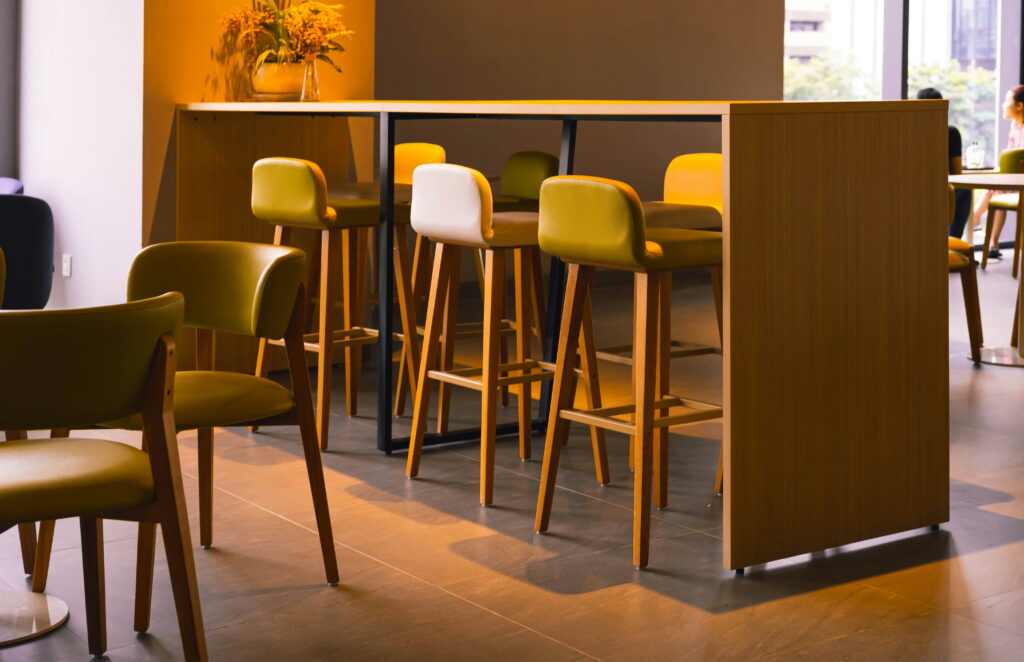 Armchairs and bar stools inside a hotel lobby
